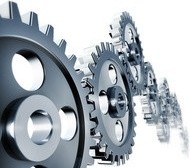 Ein Bild von mehreren ineinander greifenden Metallrädern, die eine mechanische Bewegung darstellen.