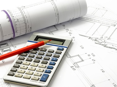 Ein Taschenrechner und ein Bleistift liegen auf einer Bauplanzeichnung.